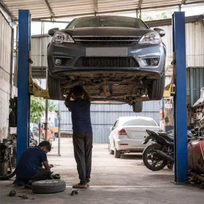 Car service bay with vehicle on lift